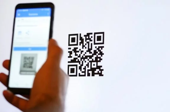 Scan QR code with smartphone on computer monitor.